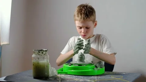 Boy learning to stick on a potter's wheel. Long or Wide Shot  Stock Footage 151643238