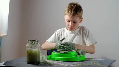 Boy learning to stick on a potter's wheel. Long or Wide Shot  Stock Footage 151643256