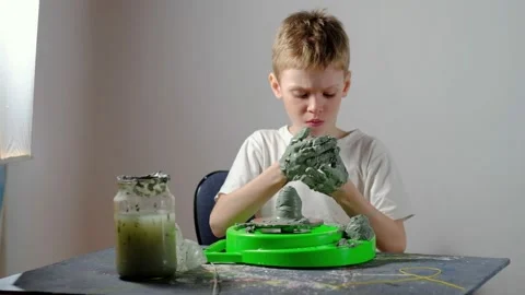 Boy learning to stick on a potter's wheel. Long or Wide Shot  Stock Footage 151643280