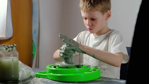 Boy learning to stick on a potter's wheel. Long or Wide Shot  Video stock 151643487