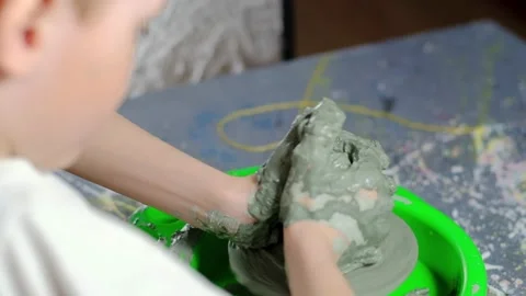 Boy learning to stick on a potter's wheel close-up Video stock 151643616