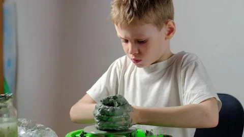Boy learning to stick on a potter's wheel close-up Video stock 151643711