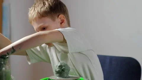 Boy learning to stick on a potter's wheel close-up Video stock 151643740