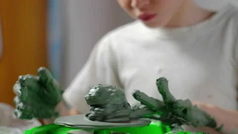 Boy learning to stick on a potter's wheel close-up Video stock 151643757
