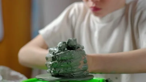 Boy learning to stick on a potter's wheel close-up Video stock 151643766
