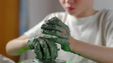 Boy learning to stick on a potter's wheel close-up Video stock 151643782