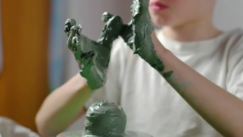 Boy learning to stick on a potter's wheel close-up Video stock 151643799