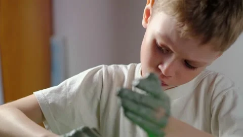 Boy learning to stick on a potter's wheel close-up Video stock 151643822