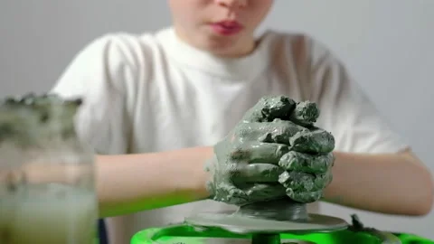 Boy learning to stick on a potter's wheel close-up Video stock 151643873