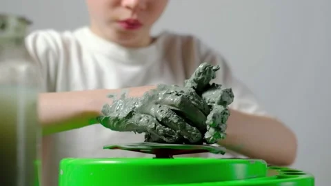 Boy learning to stick on a potter's wheel close-up Video stock 151644027