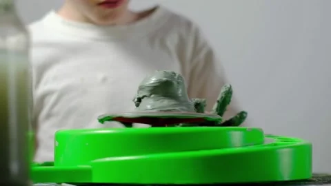 Boy learning to stick on a potter's wheel close-up Video stock 151644063