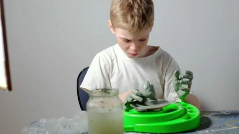 Boy learning to stick on a potter's wheel. Long or Wide Shot  Video stock 151644194