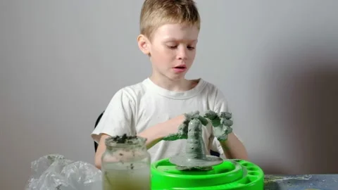 Boy learning to stick on a potter's wheel. Long or Wide Shot  Vídeos de archivo 151644324