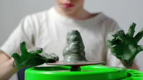 Boy learning to stick on a potter's wheel close-up Video stock 151644382