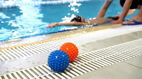 Boy learning to swim in the pool Stock Photos