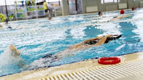 Boy learning to swim in the pool 스톡 사진