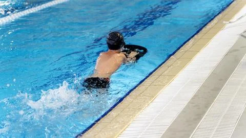 Boy learning to swim in the pool Stock Photos