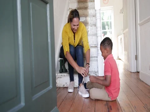 Boy learning to tie shoe laces Stock Footage 81071115