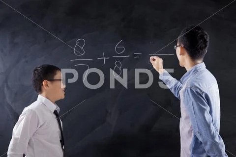 Boy learns math lesson in class Stock Photos