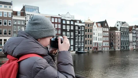 The boy learns to photograph. A young boy takes a camera. Stock Footage 110773838