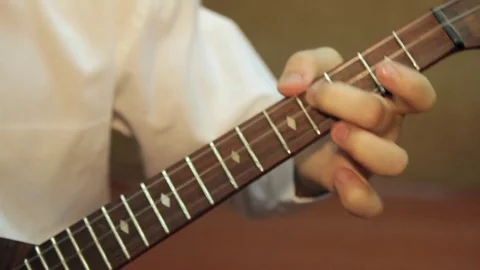 A boy learns to play the balalaika, close up Stock Footage 71432473