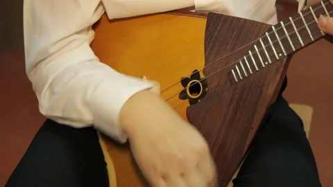 A boy learns to play the balalaika, close up Stock Footage 71432514