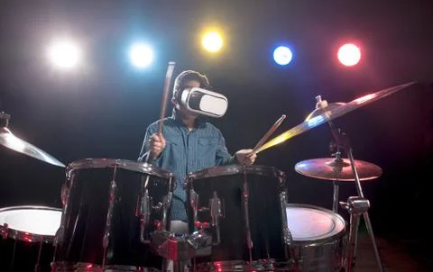 The boy learns to play drums, with glasses for virtual reality Stock Photos