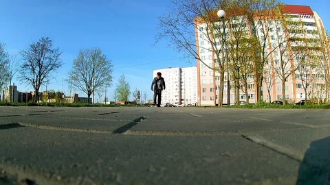 Boy learns to ride a skateboard Stock Footage 75458347