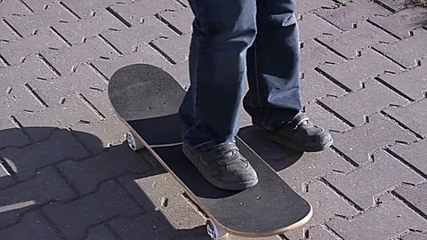 Boy learns to ride a skateboard Stock Footage 75583846