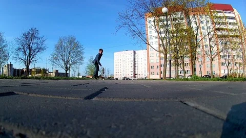 Boy learns to ride a skateboard Stock Footage 75588154