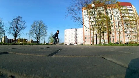 Boy learns to ride a skateboard Stock Footage 75590498