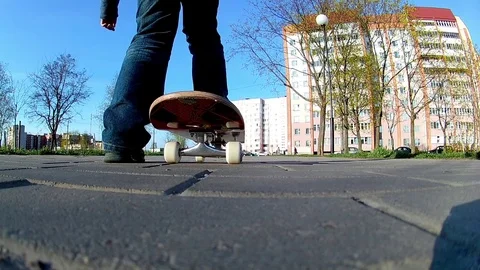 Boy learns to ride a skateboard Stock Footage 75592689