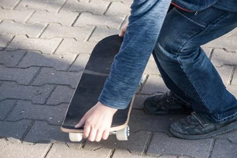 Boy learns to ride a skateboard Stock Photos