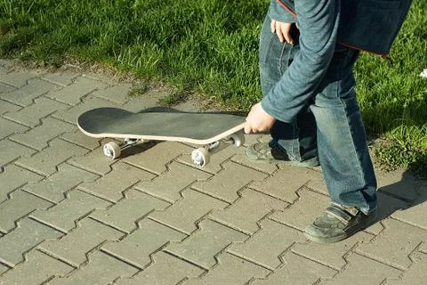 Boy learns to ride a skateboard Stock Photos