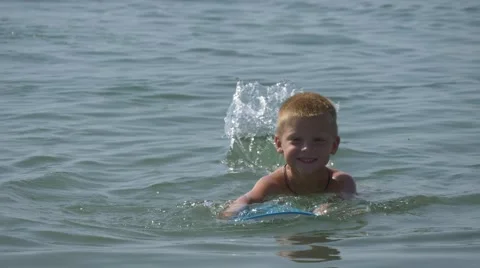 Boy learns to swim Stock Footage 64649473