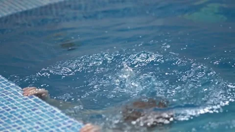 Boy learns to swim on his back 스톡 동영상 310061267