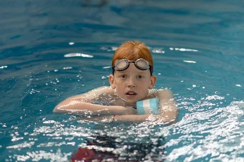 Boy learns to swim Stock Photos