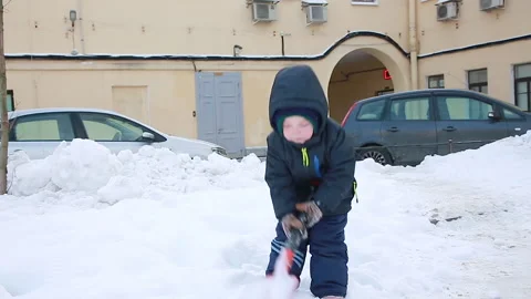 A boy learns to work with a shovel Stock Footage 166753624