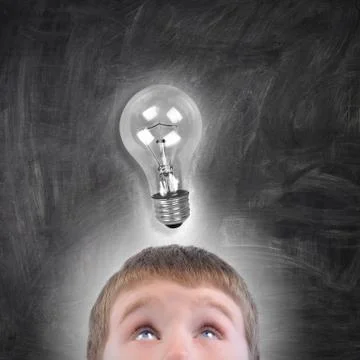 Boy with light bulb idea looking up Stock Photos