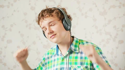 The boy listens to music Video stock 27794192