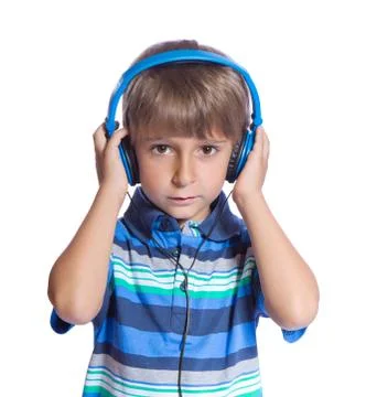The boy listens to music on headphones. isolate on white. Stock Photos
