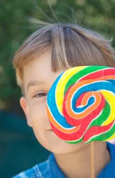 Boy with lollipop Stock Photos