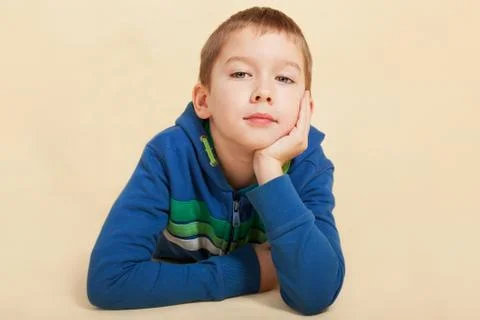 Boy looking into the camera and thinking. Stock Photos