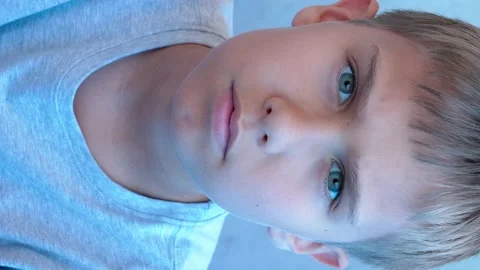 Boy looking to camera, try to see something interesting in front of him. Video Video stock 132948291