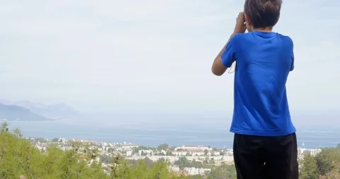 Boy looking at the city below Stock Footage 90175561