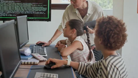 Boy Looking at Classmate at Lesson of Programming in Computer Class Stock Footage 316478292