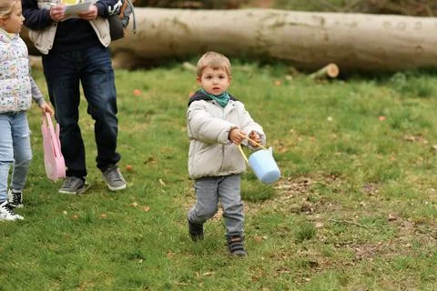 A boy looking for eggs in a bag for Easter Stock Photos