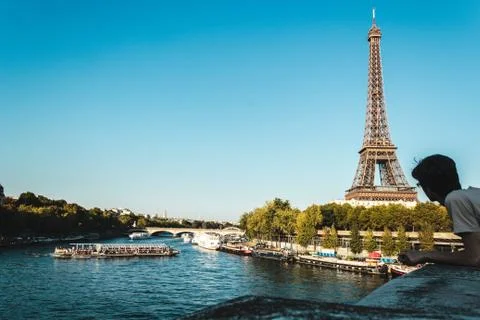 Boy Looking at Eiffel Tower and The Seine River in Paris, France Stock Photos