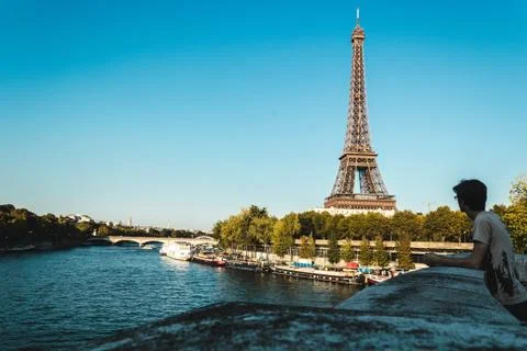 Boy Looking at Eiffel Tower and The Seine River in Paris, France Stock Photos