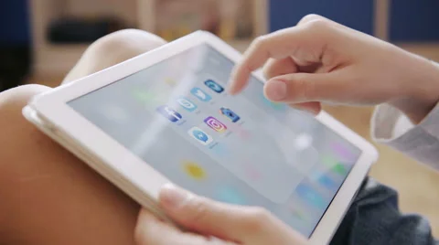 A boy looking Facebook application on Apple ipad display Stock Footage 67975707